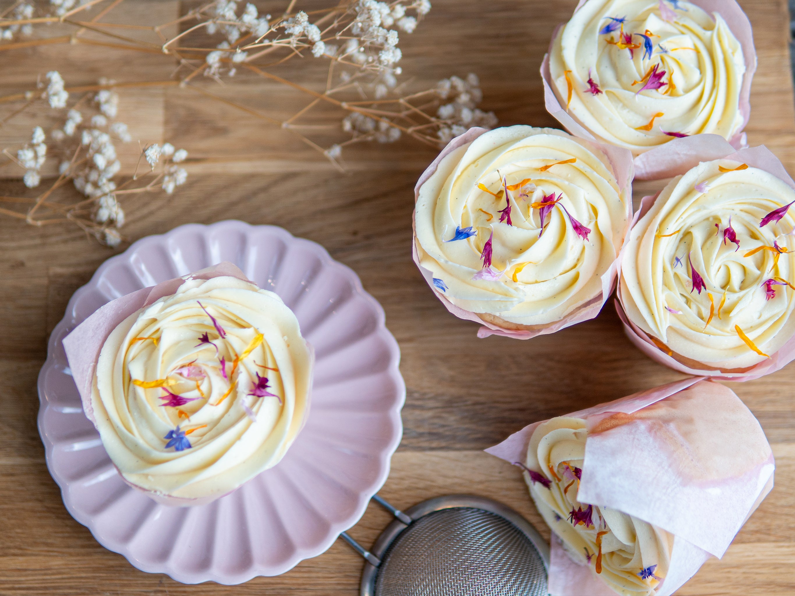 Our afternoon tea muffins with clotted cream frosting and decrative dried flower petals on top