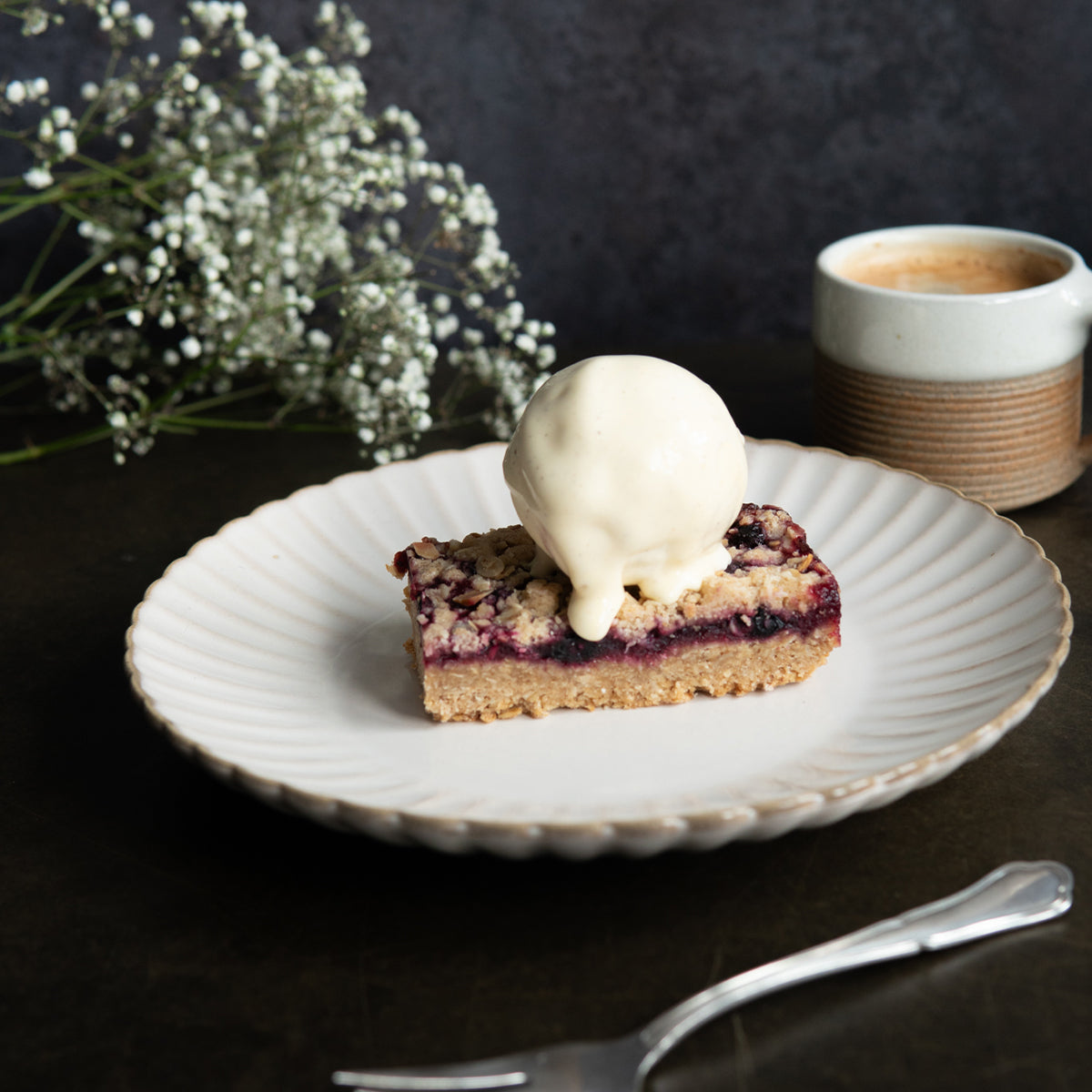 Warmed apple & blackcurrant crumblejack served with ice cream