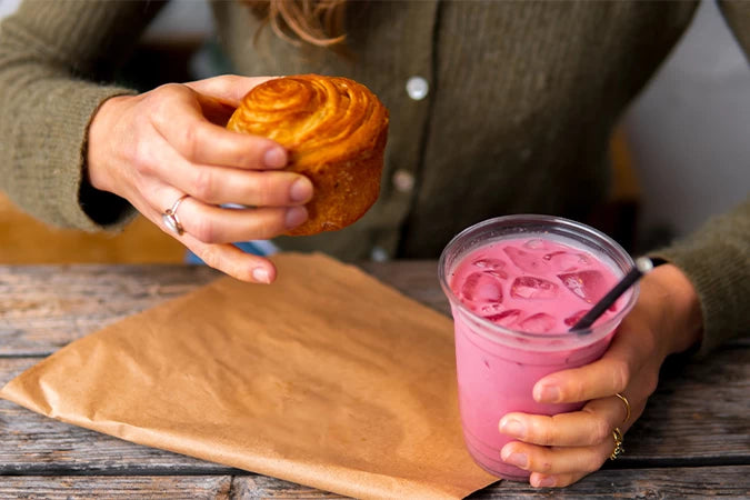 An iced pink chai latte made with Blendsmiths