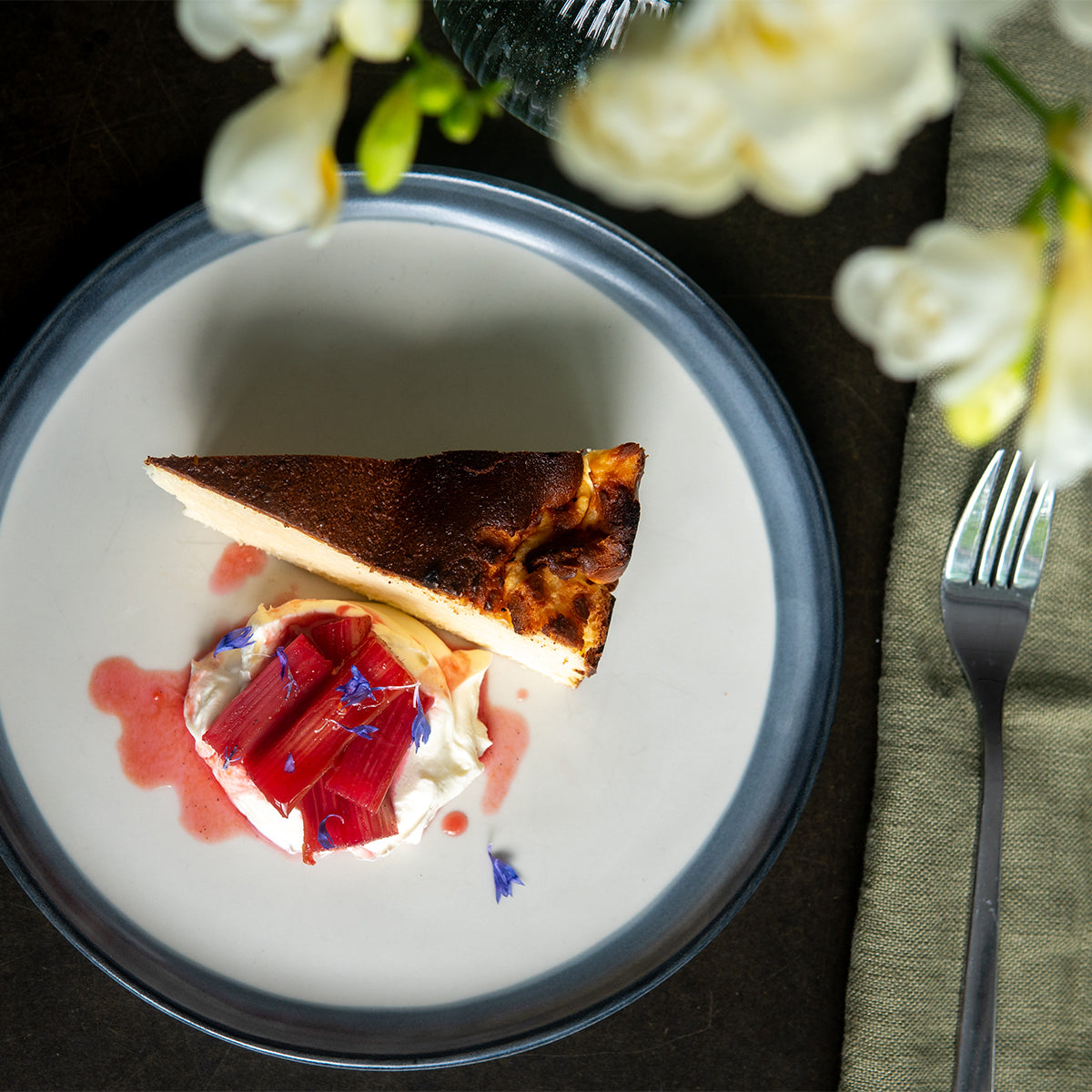 Burnt basque served with clotted cream and poached rhubarb