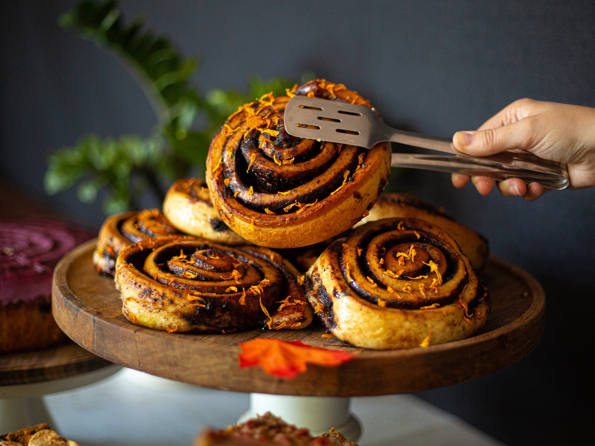 Chocolate and orange swirl buns on a wooden stand