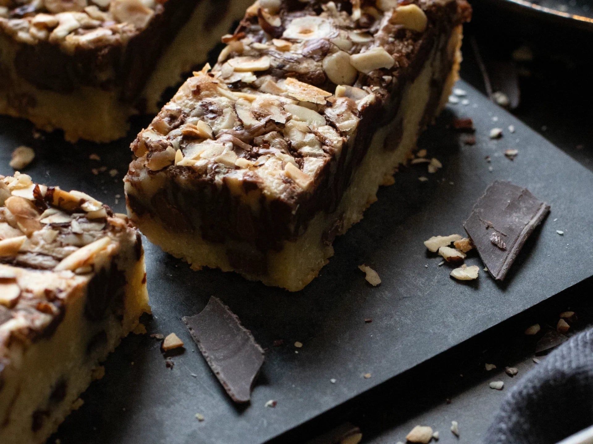 Close-up of a Hazelnut Blondie chocolate and nut dessert on a dark surface