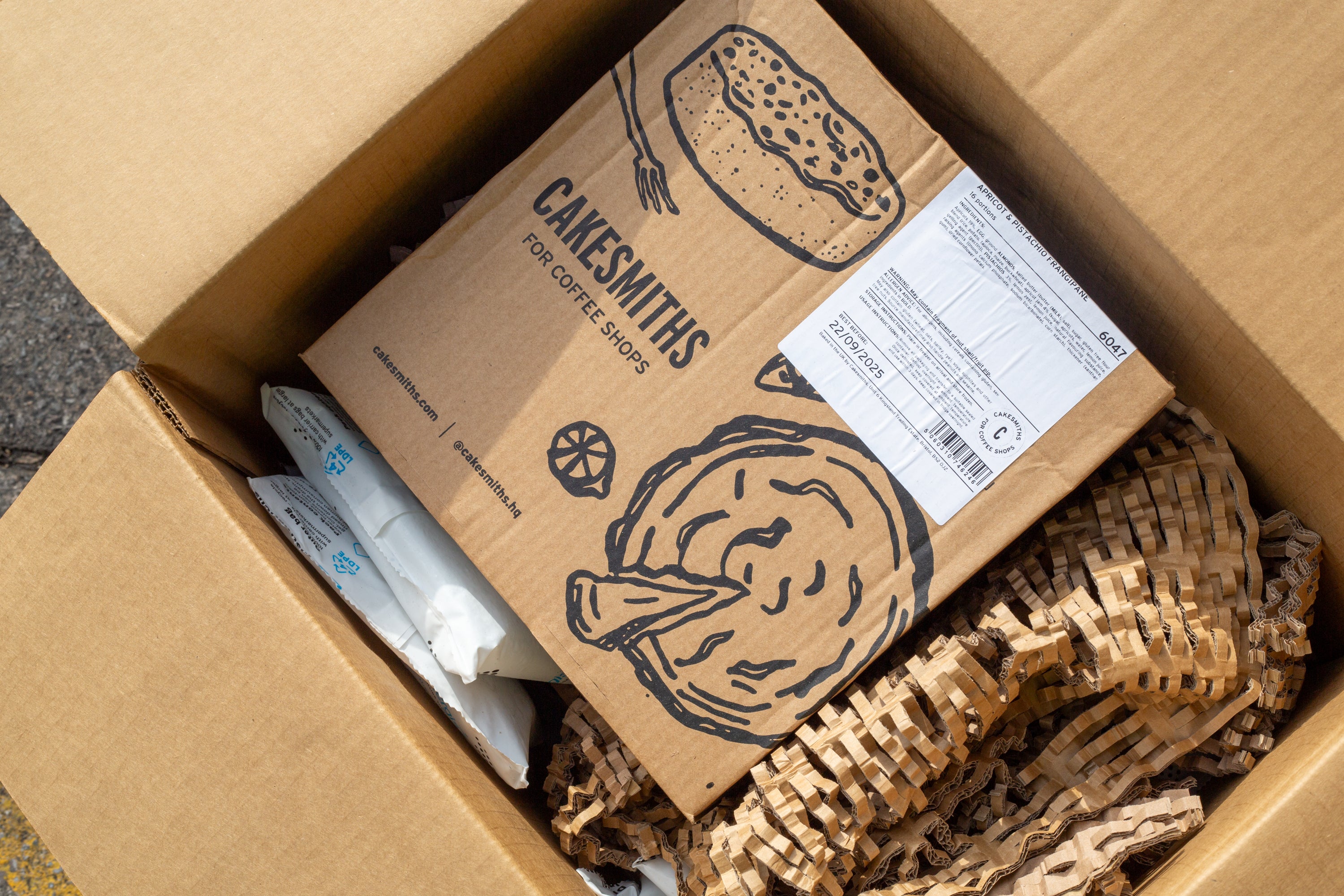 Cardboard box with 'Cakesmiths' branding and temperature controlled packaging