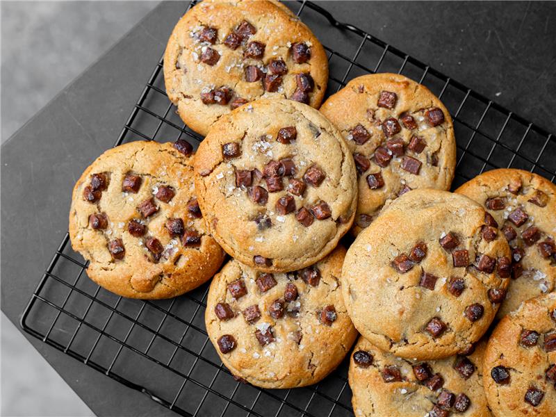 Chocolate Chip Sea Salt Cookie on a cooling rack with a gray background
