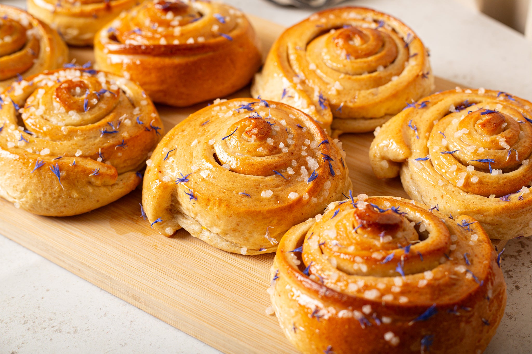 A tray of our wholesale sticky buns with a lemon drizzle glaze