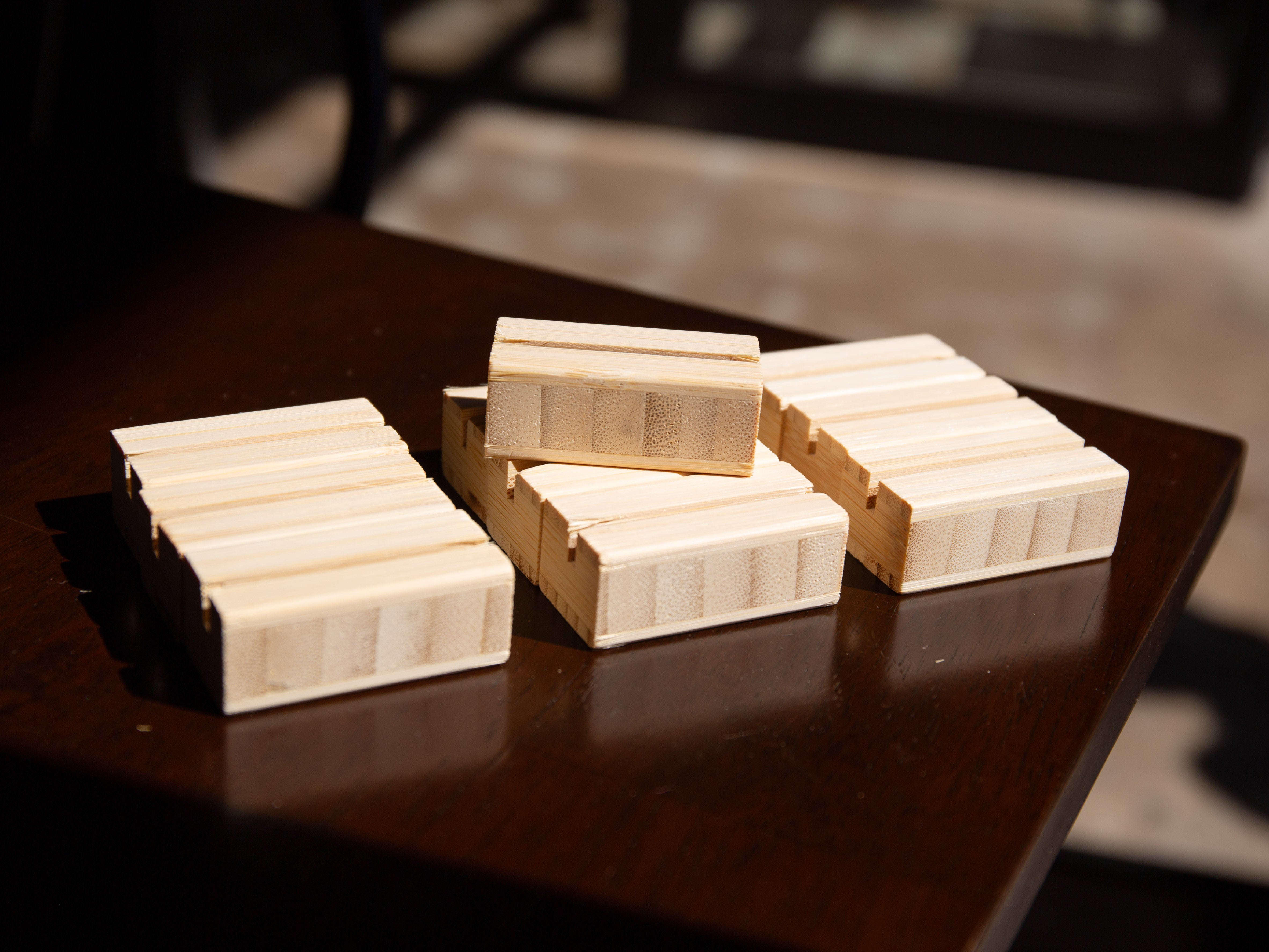 Wooden Bamboo Product Display Card Stands on a dark surface