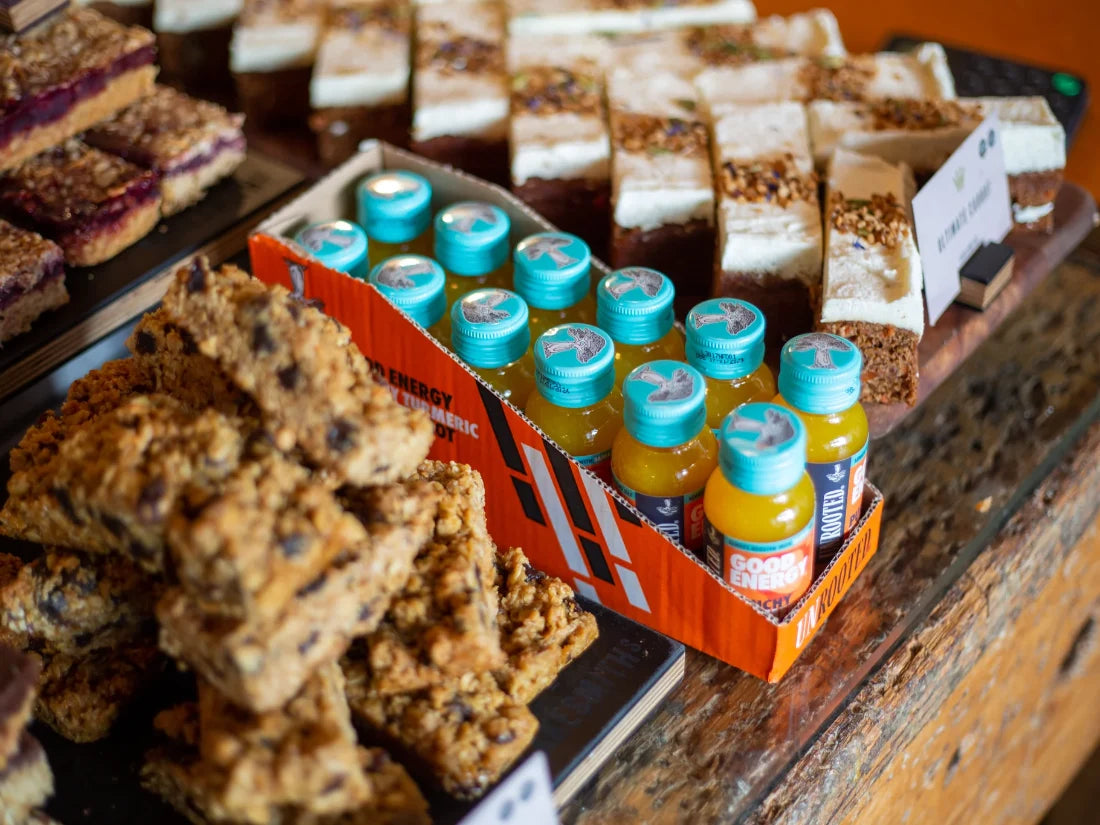 Unrooted Health Shots energy drinks on a wooden counter top