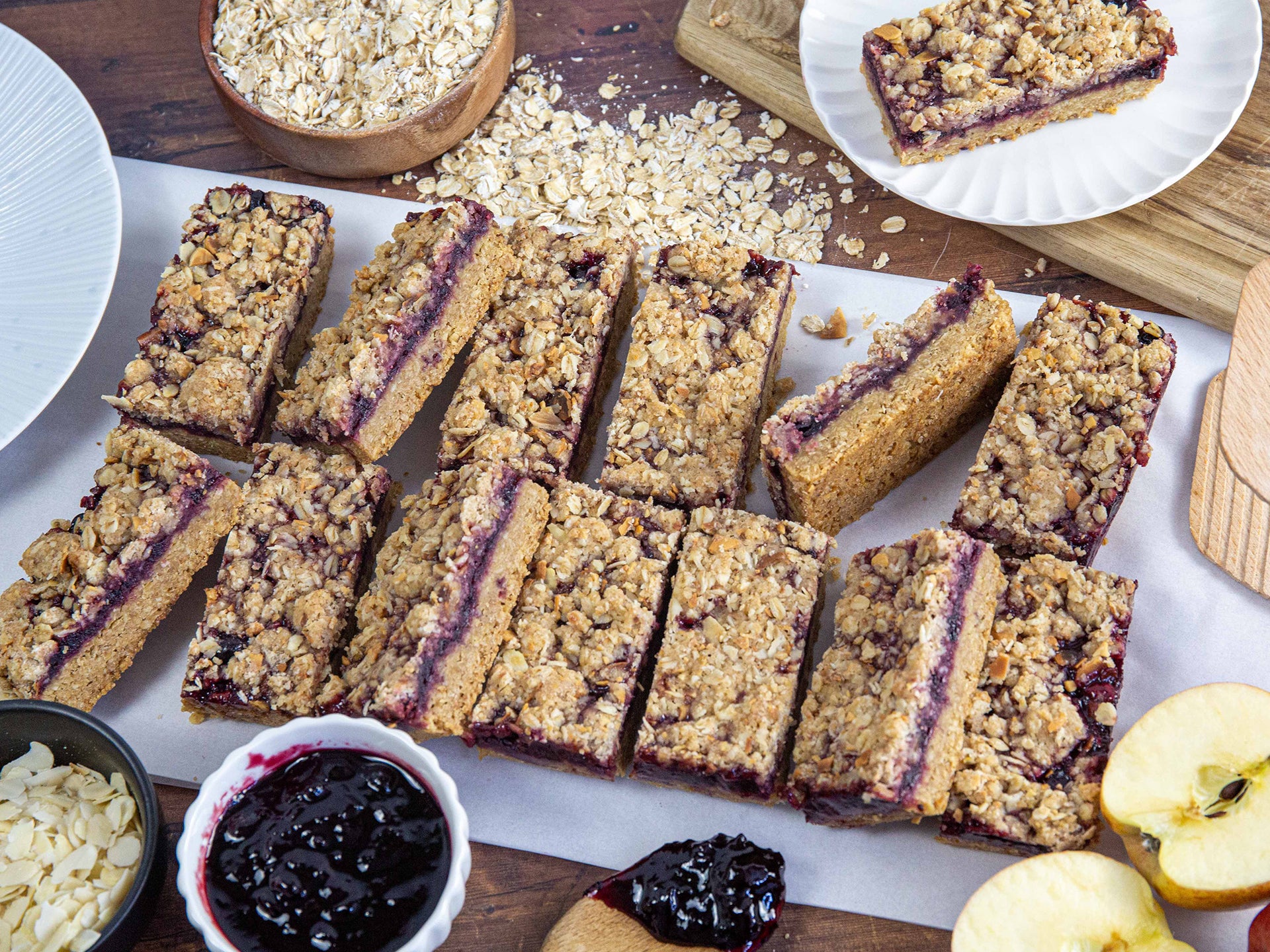 Wholesale flapjacks with a crumble topping and a layer of apple & blackcurrant jam