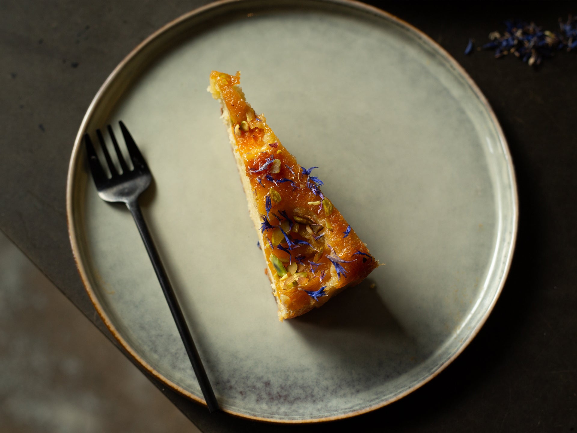 A slice of Apricot and Pistachio Frangipane cake