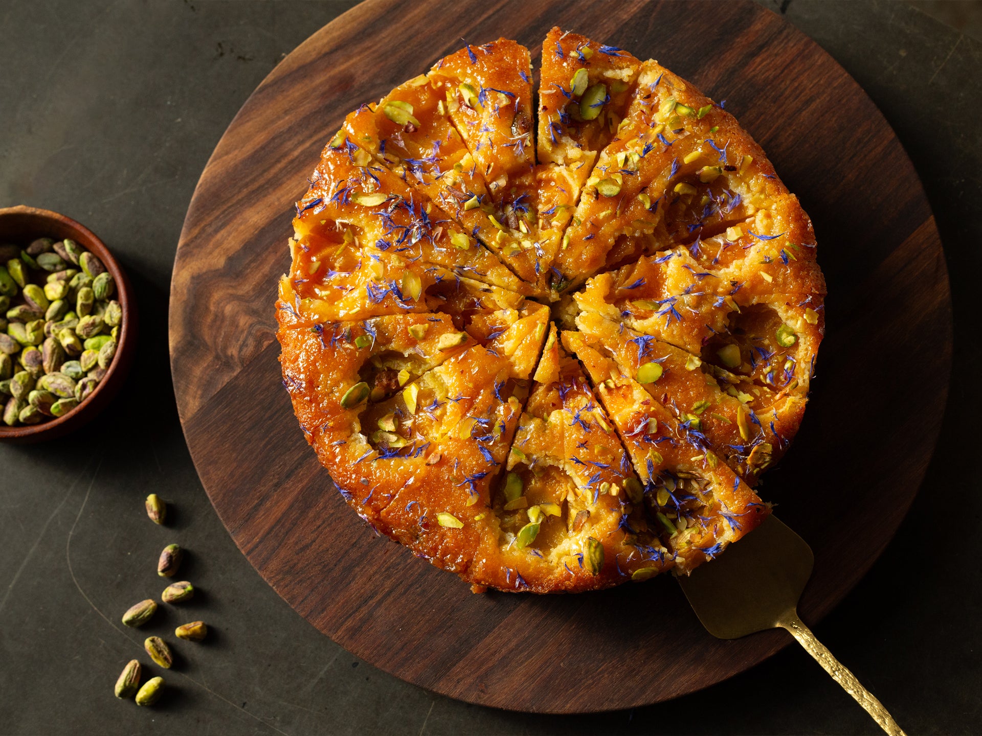 An overhead shot of our wholesale 16 portioned apricot and pistachio frangipane round