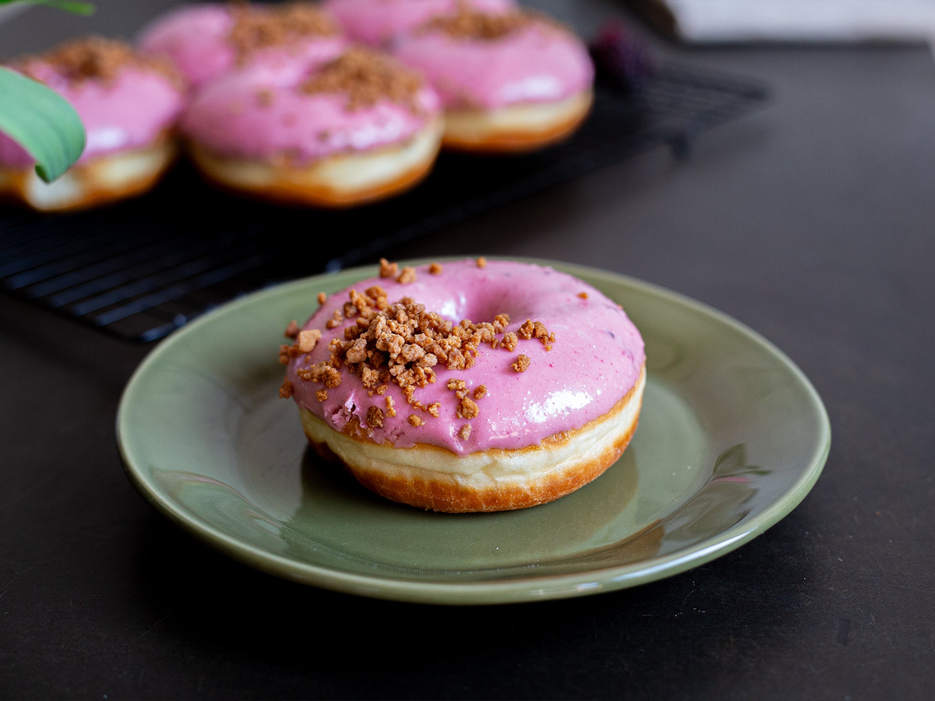A Blackberry Crumble Doughnuts from Cakesmiths served on a plate