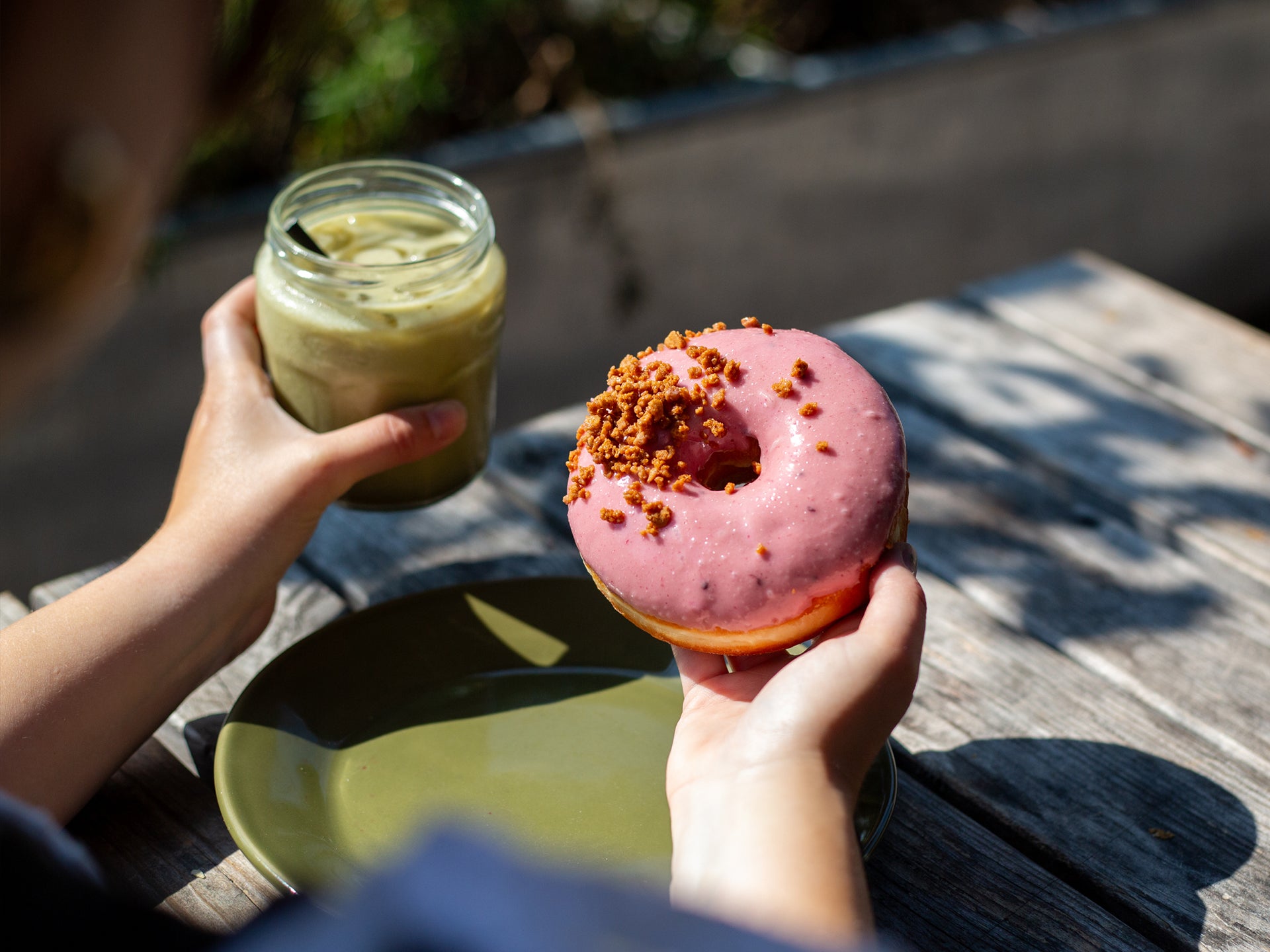 A Blackberry Crumble Doughnut served with a matcha latte