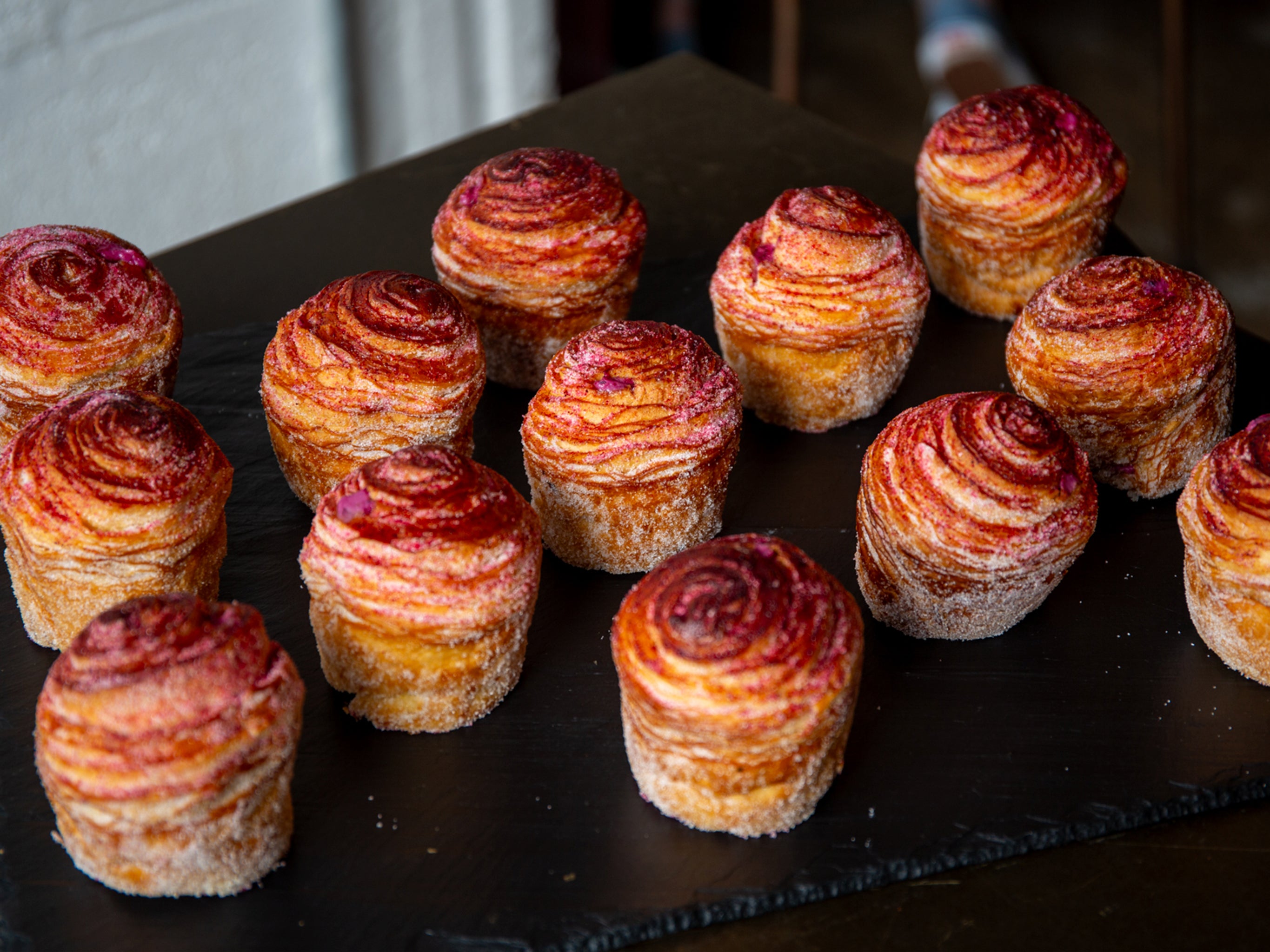 A tray of blackcurrant cheesecake cruffins