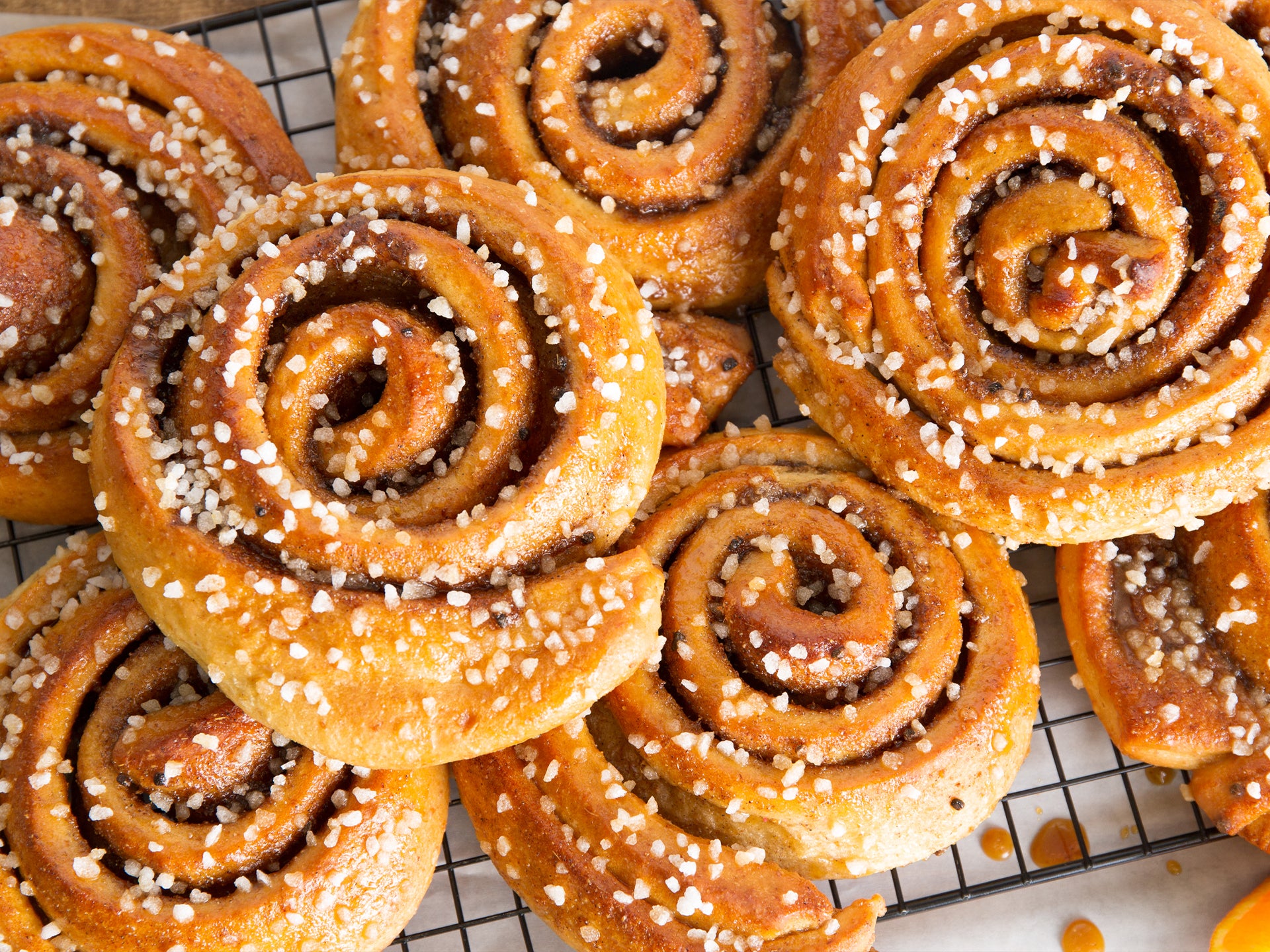 Baked cardamom and orange buns, sprinkled with sugar