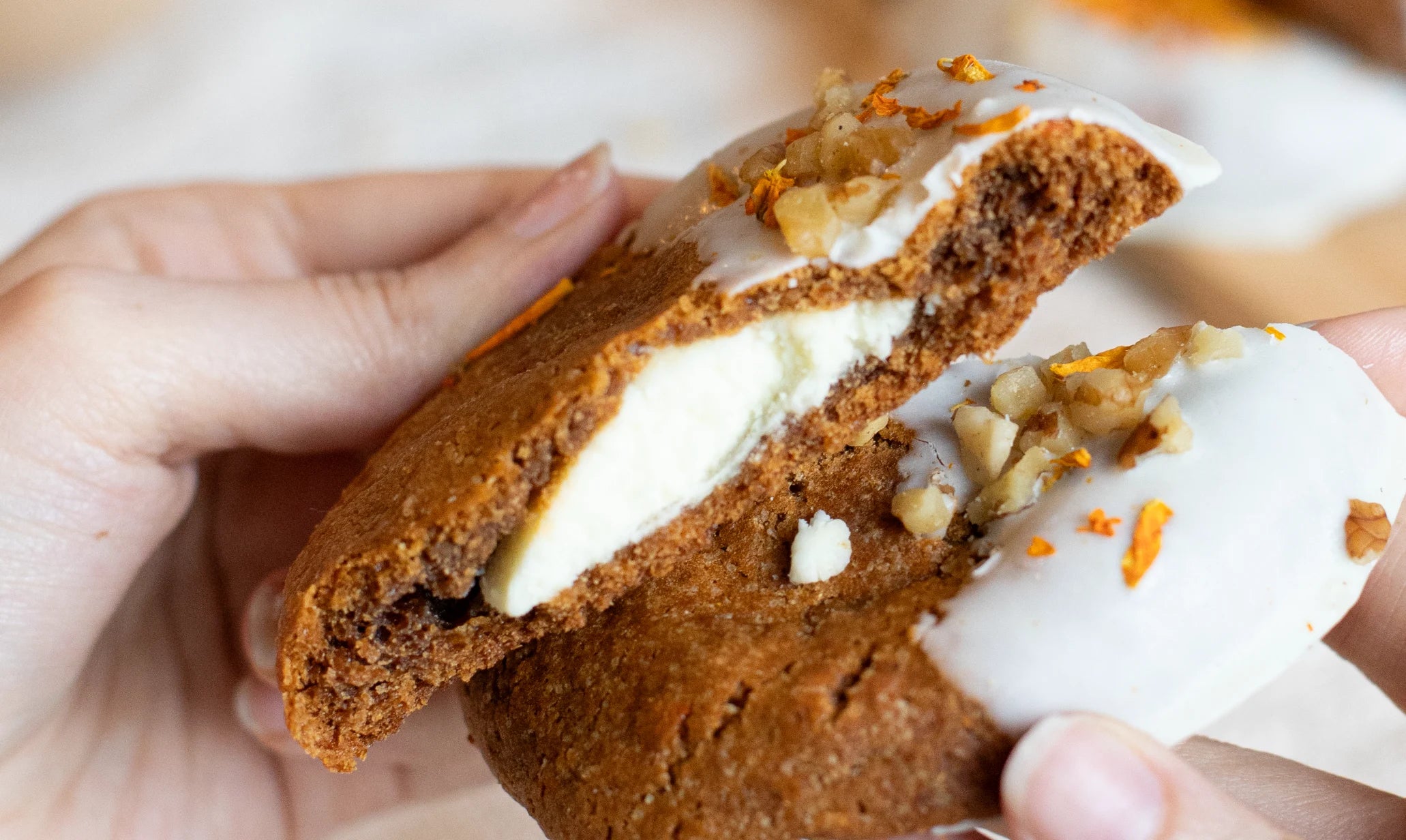 Person holding a Carrot Cake Cookies sandwich with cream filling and nuts