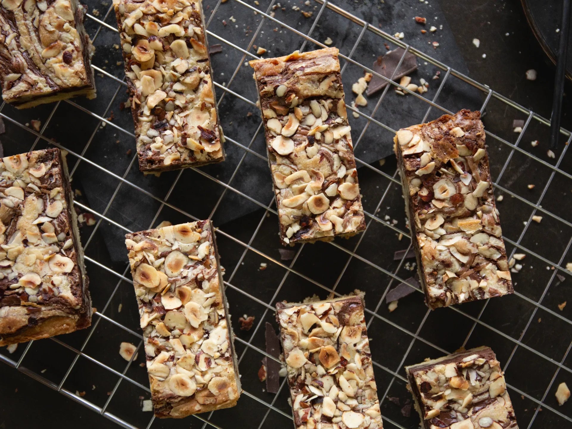 Hazelnut Blondie Nuts and chocolate bars on a cooling rack