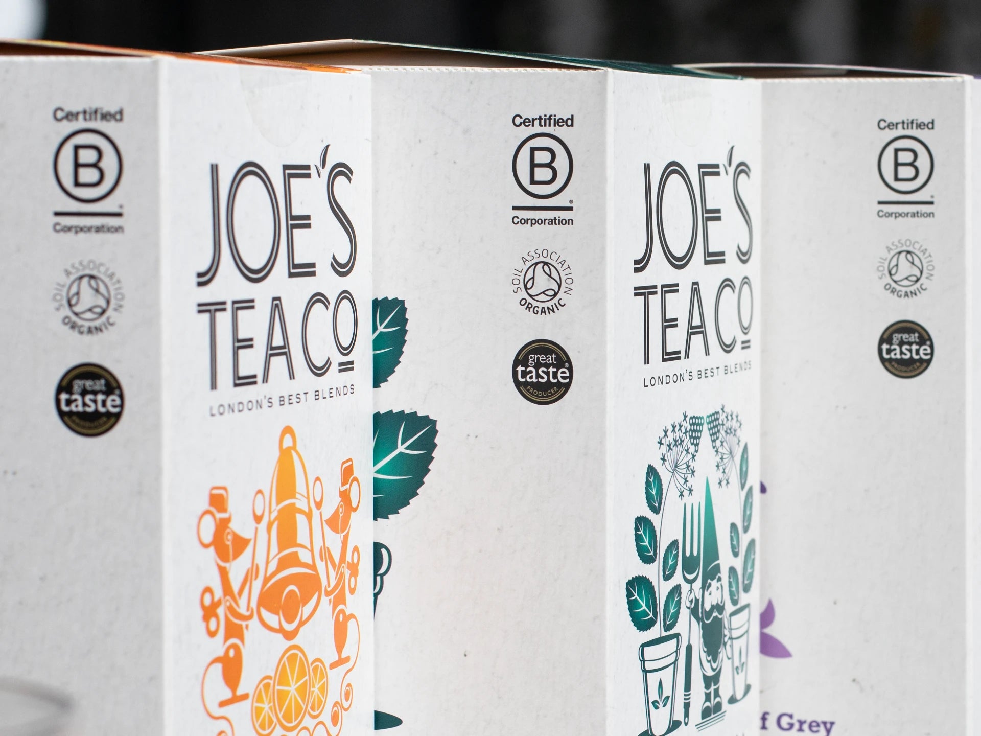 Three boxes of Joe's Tea Co. with visible branding and certification logos.