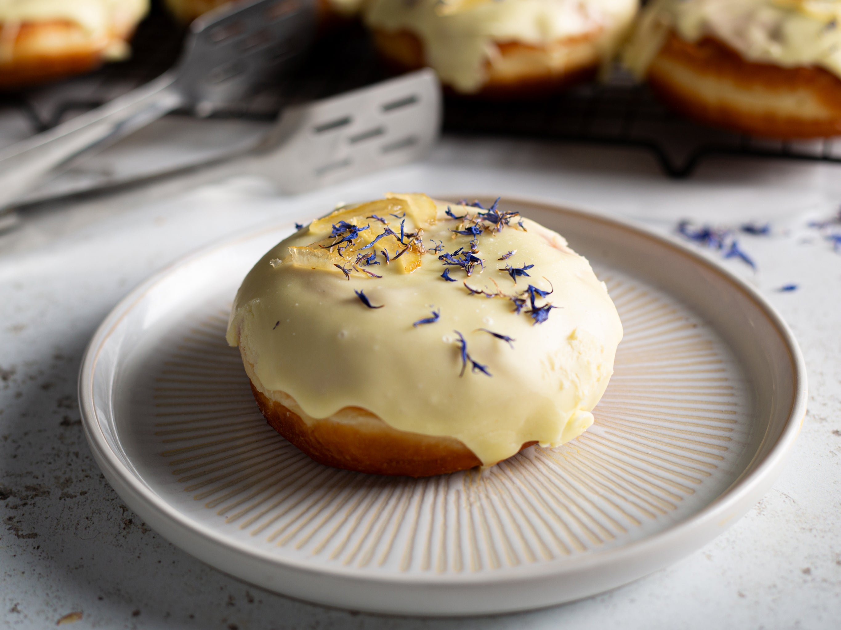 One of our wholesale lemon doughnuts filled with lemon curd and glazed with a lemon infused icing