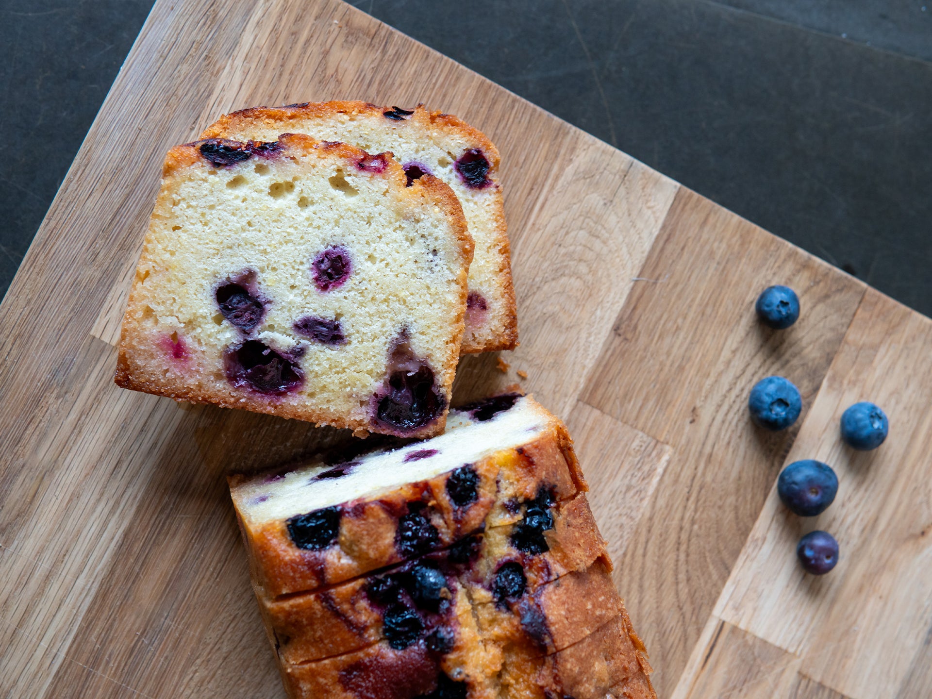 Sliced lemon loaf cake bursting with blueberries 