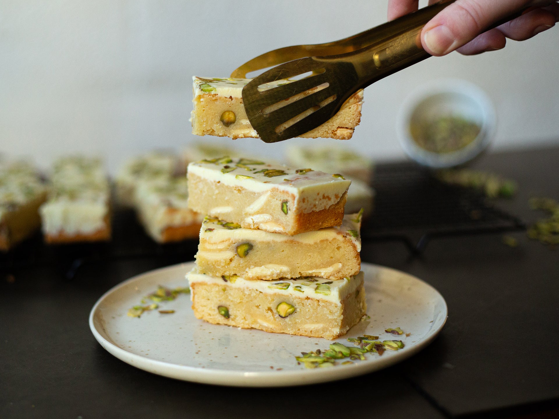 A stack of wholesale blondies flavoured wiht lemon & pistachio