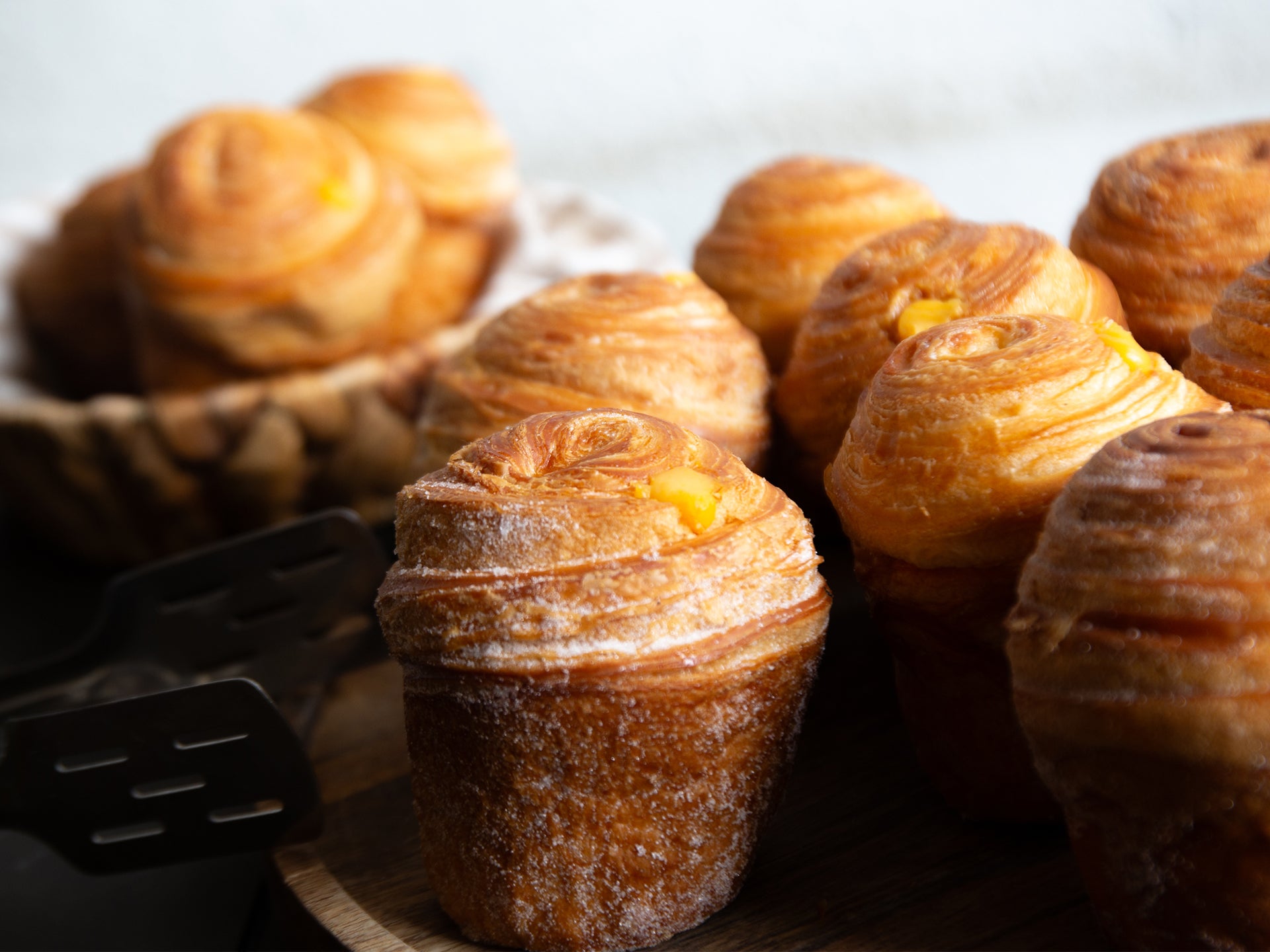 A close up of one of our Passionfruit Curd Cruffins