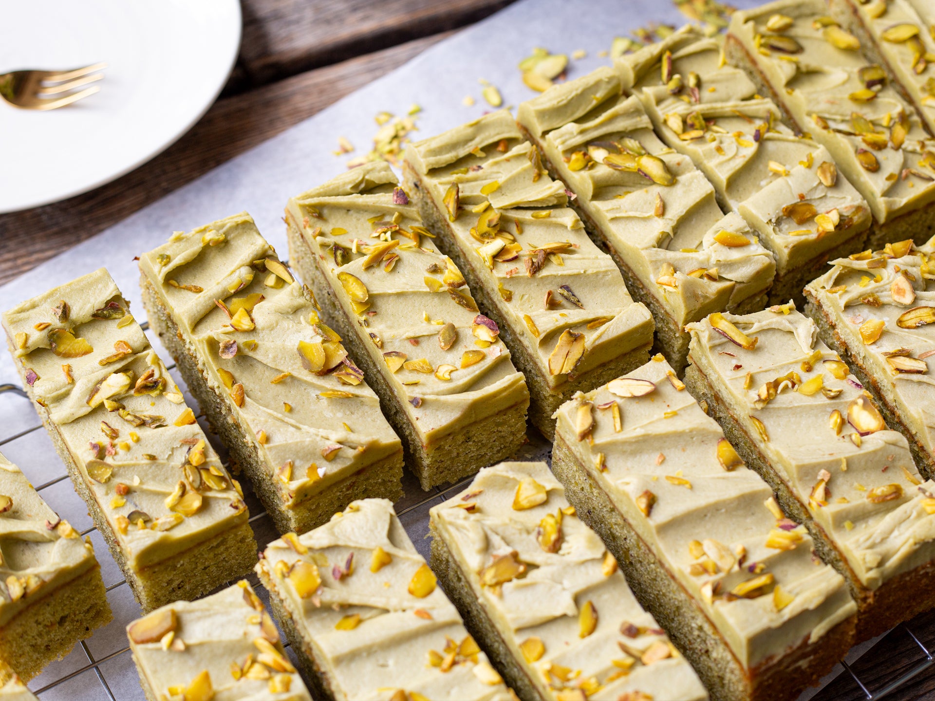 A tray of slices of Pistachio Creme traycake