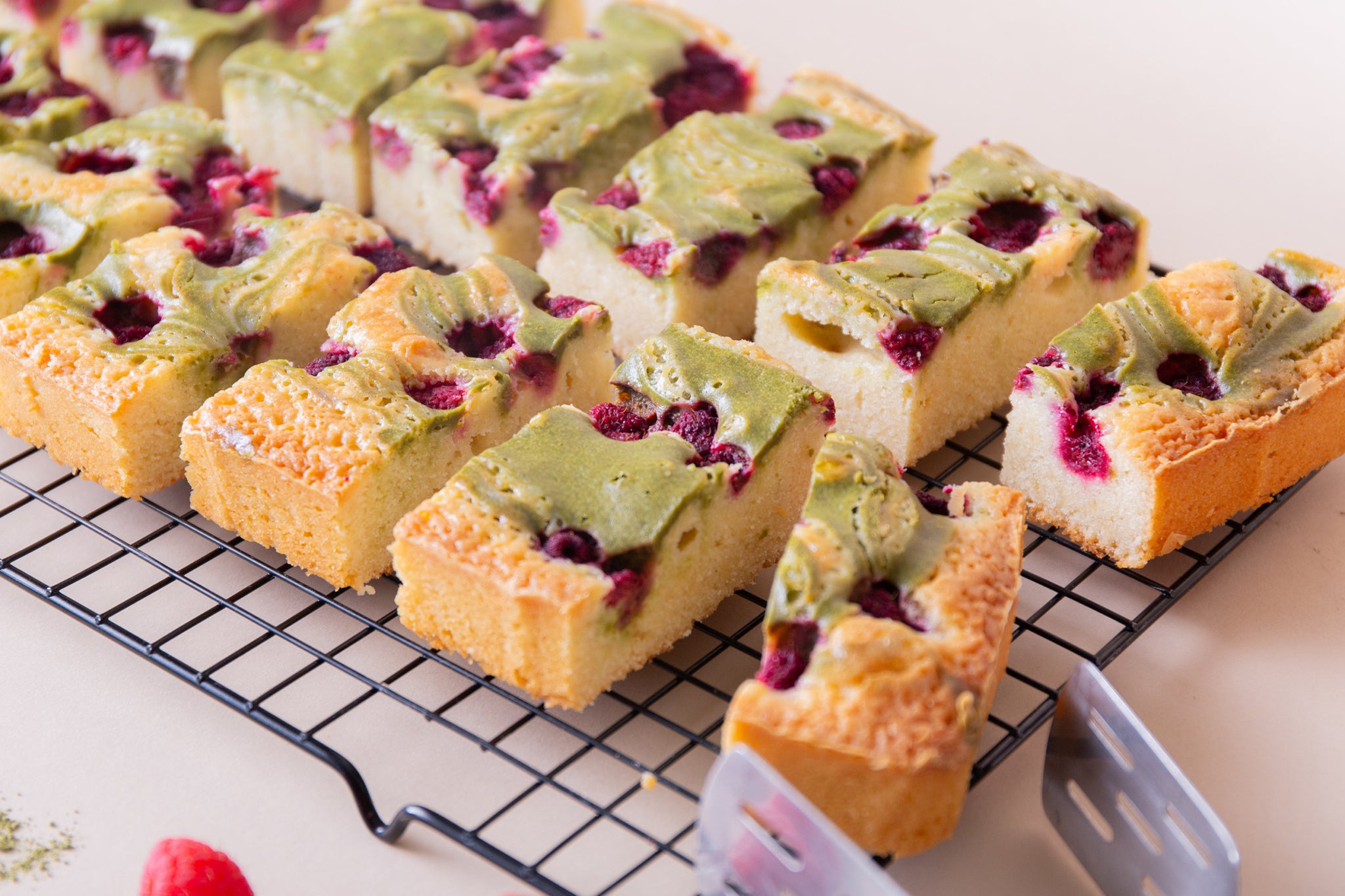 A close up of our wholesale raspberry blondies swirled with matcha cheesecake