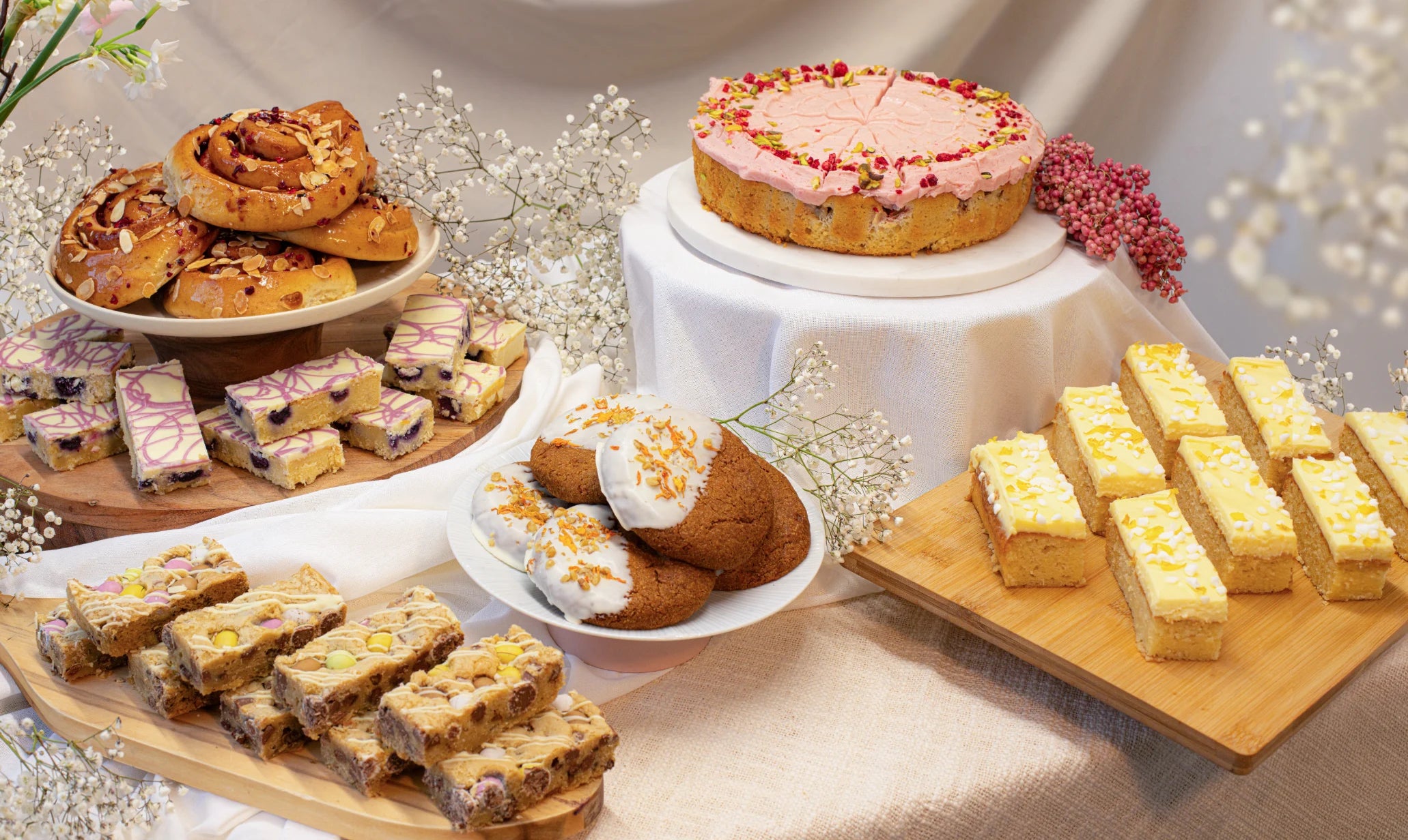 Assorted spring cakes on a table with a soft, neutral background
