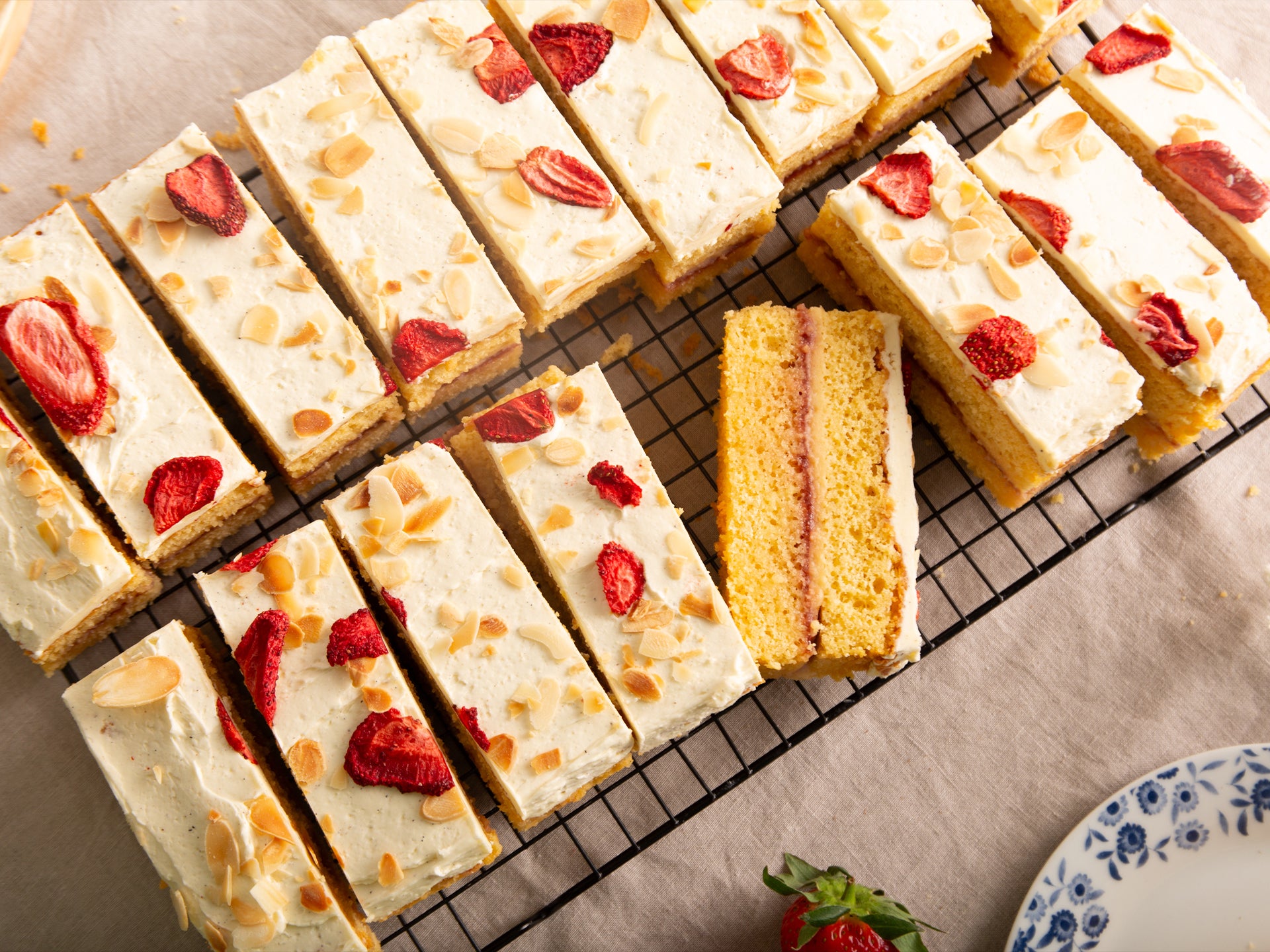 A tray of our strawberry trifle traycake topped with freeze dried strawberries and flaked almonds