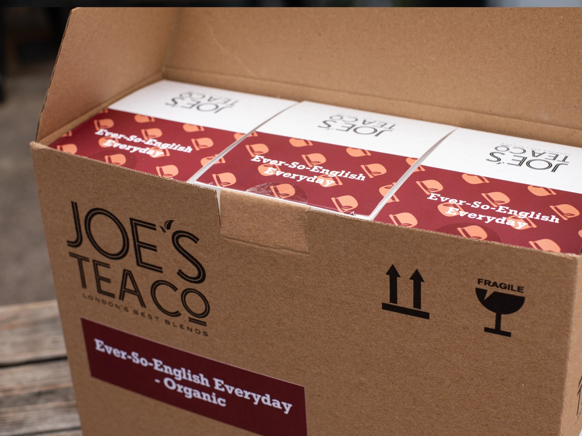 Box of Joe's Tea Co. tea boxes with visible branding and product details.