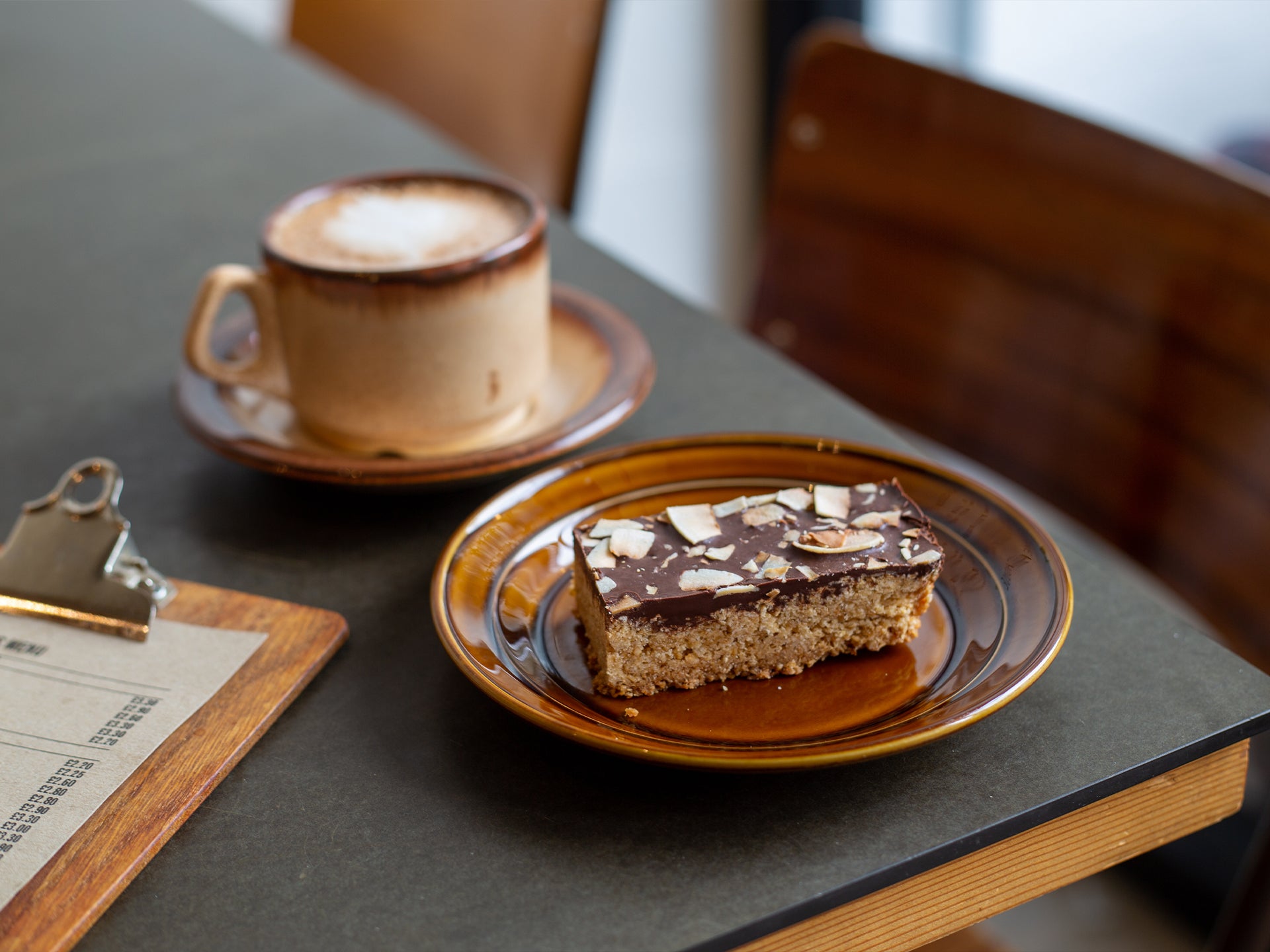 A slice of our toasted coconut and dark chocolate flapjack, made by Cakesmiths