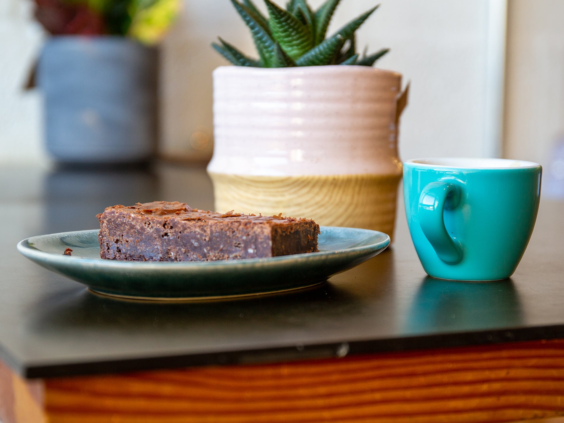A slice of ultimate almond brownie - perfect served alongside a cup of coffee in a cafe
