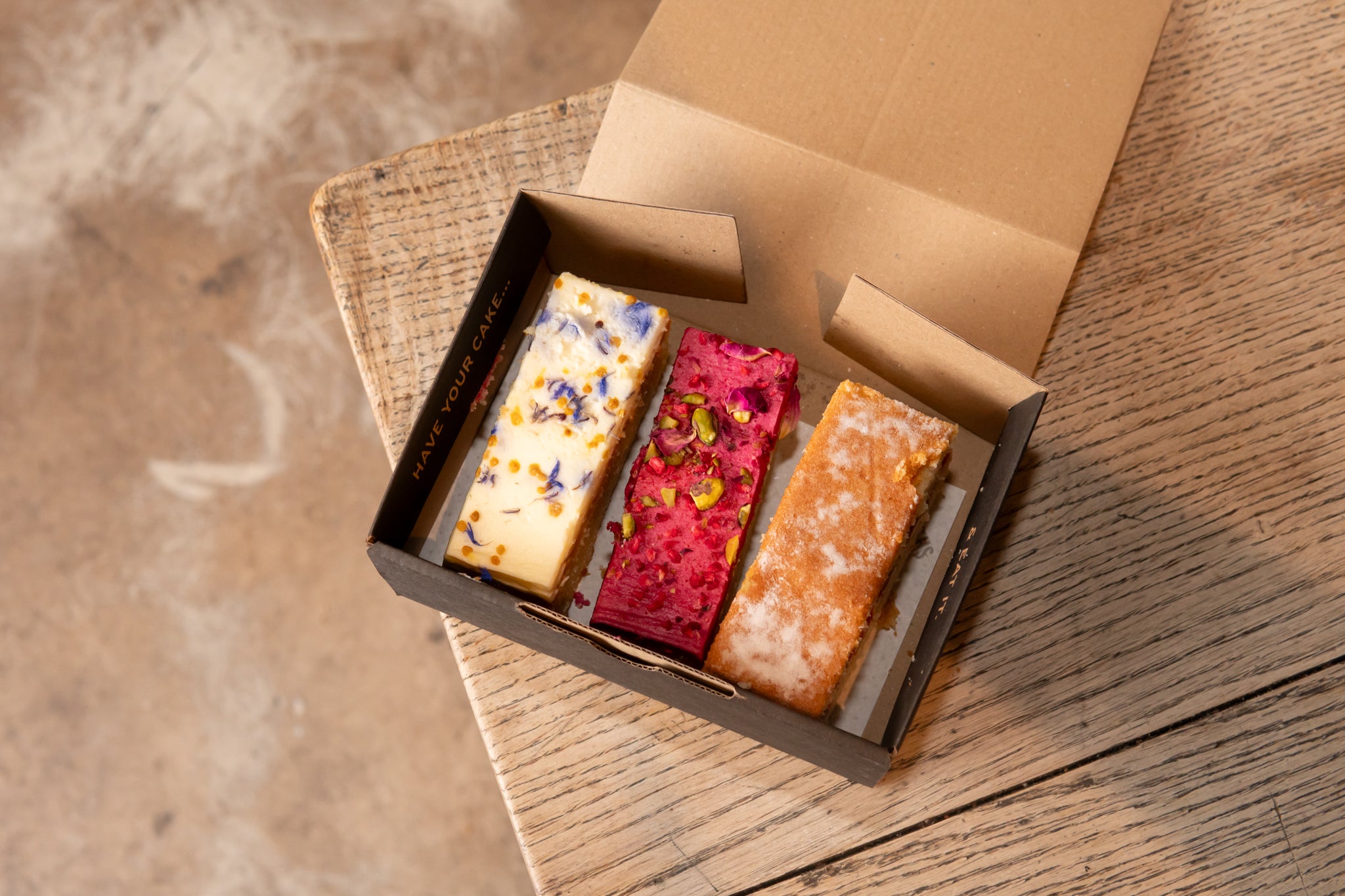 Our illustrated cake boxes fit three slices of our wholesale cake