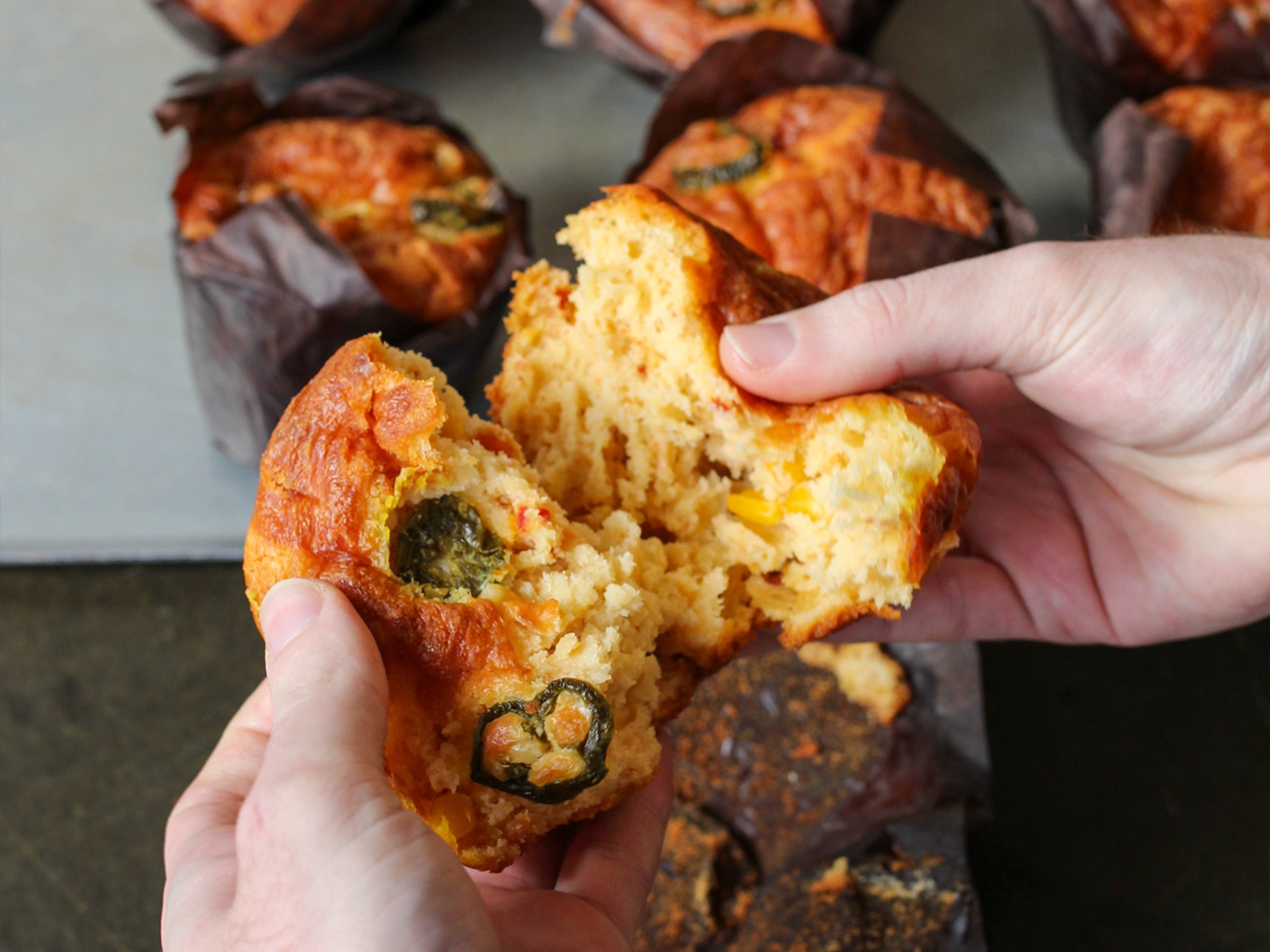 Breaking open a savoury cheese and jalapeno wholesale muffin