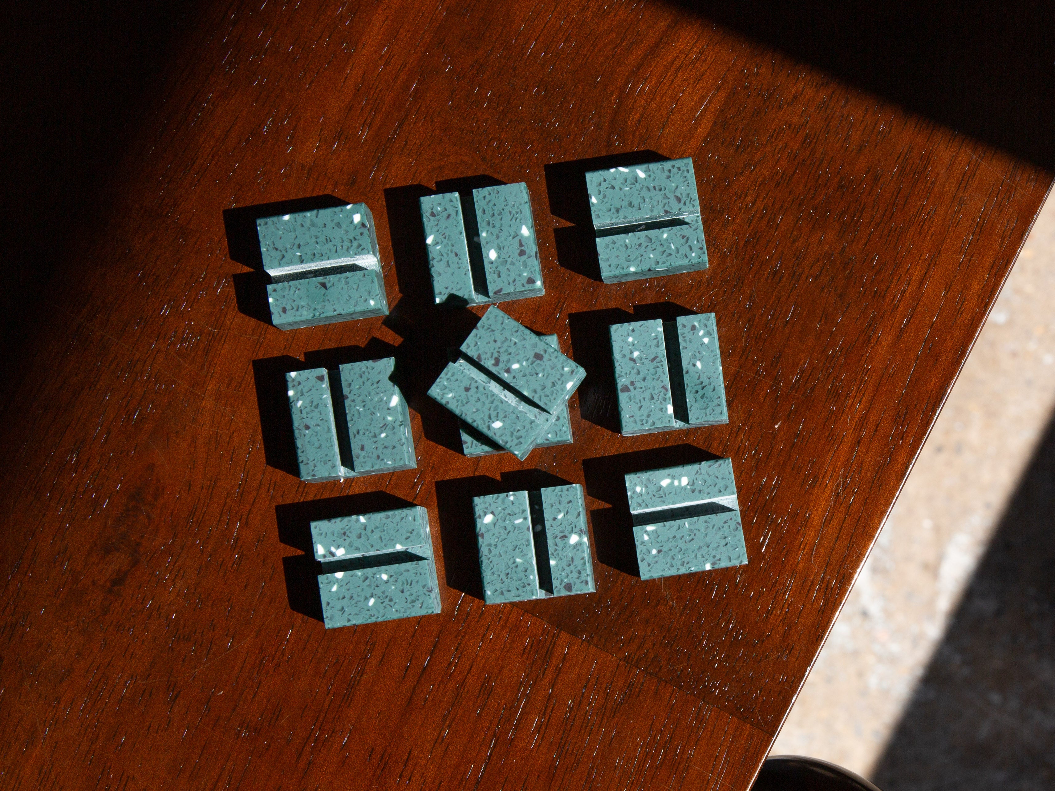 Green Terrazzo Product Display Card Stands rectangular blocks on a wooden surface