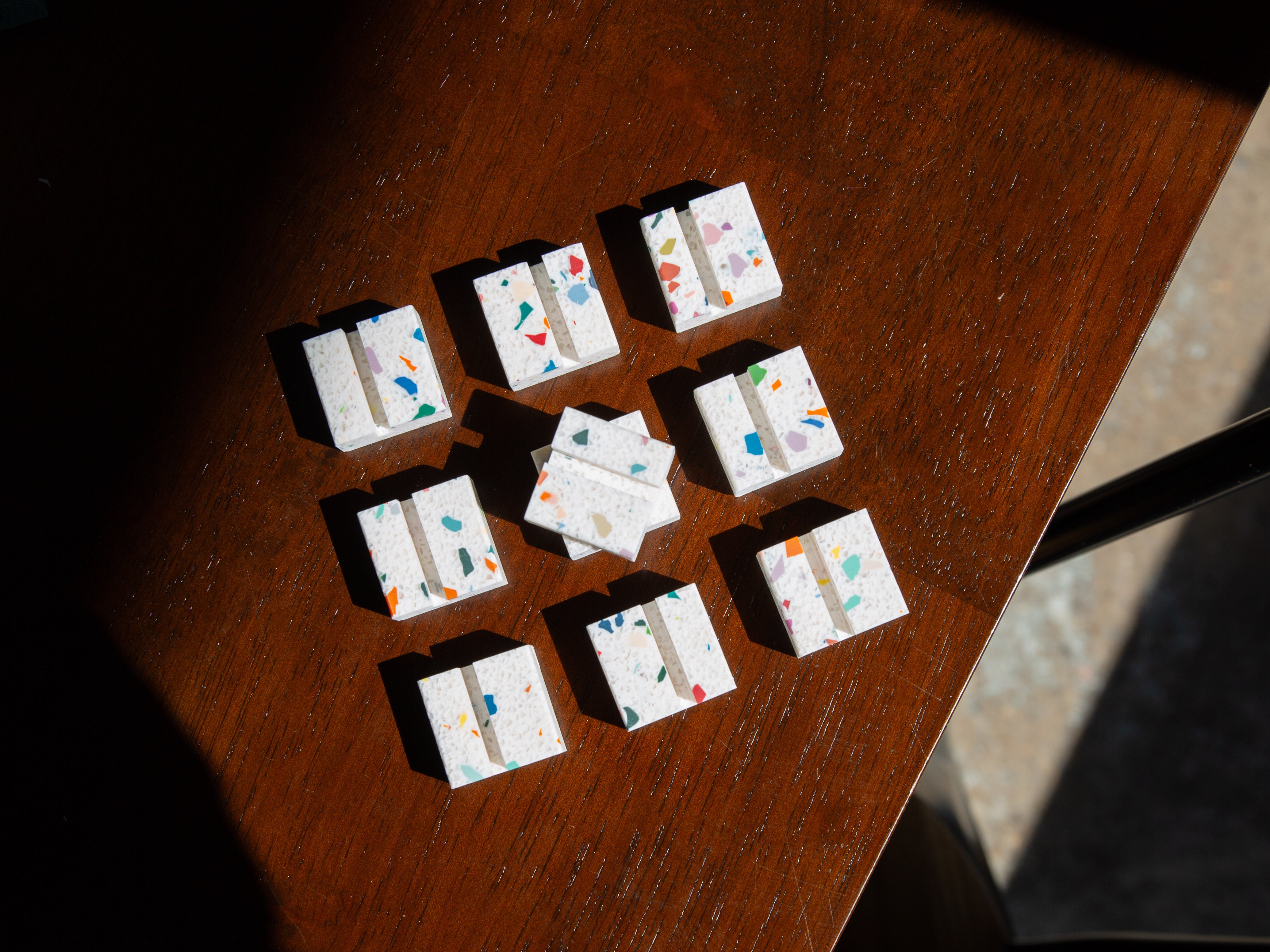 Confetti Product Display Card Stands tiles with colorful patterns on a wooden surface