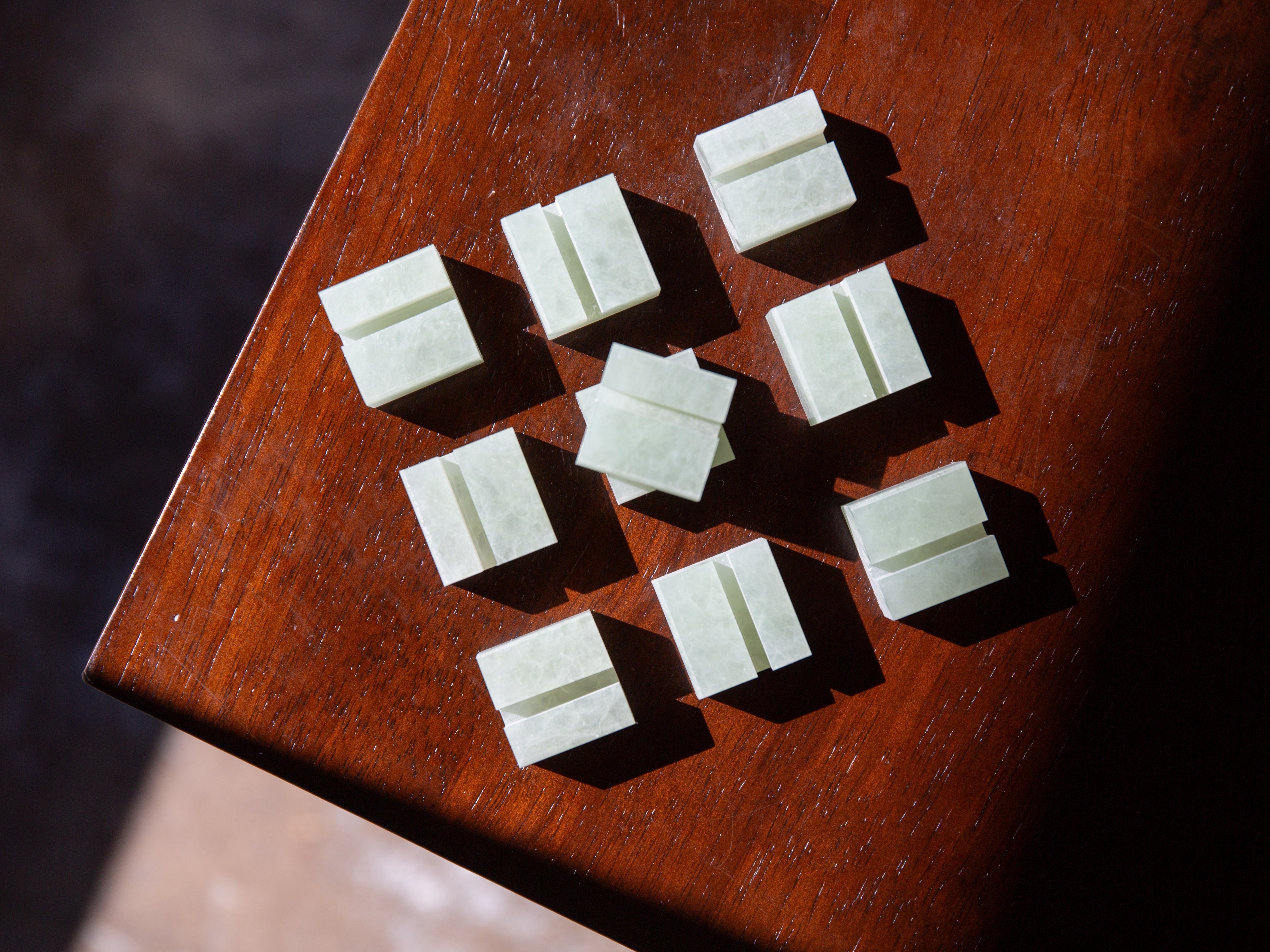 Green square Jade Karlite Product Display Card Stands on a wooden surface